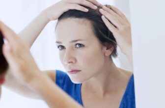 Woman applying cream for seborrheic dermatitis on face