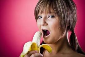 Calories in Half Banana: Nutrition, Carbs, and Portion Guide 2 woman eating half banana healthy low calorie snack