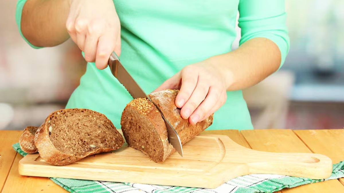 How Many Calories in a Slice of Whole Wheat Bread? Nutrition & Benefits 1 Cutting a slice of whole wheat bread to measure how many calories are in one slice