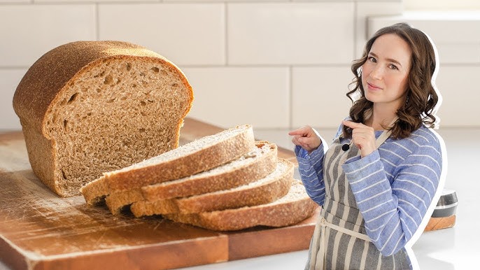 How Many Calories in a Slice of Whole Wheat Bread? Nutrition & Benefits 2 Woman showing one slice of whole wheat bread as an example of calorie portion size