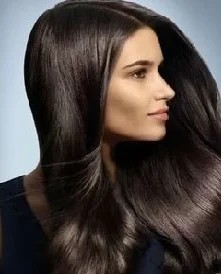 Woman with healthy shiny hair after fixing oily hair problems