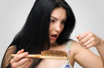 Woman worried about hair loss while washing hair in the shower