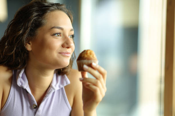 Low Calorie Apple Muffin: Calories, Nutrition & Healthy Benefits 2 Woman eating a low calorie apple muffin as part of a healthy breakfast routine
