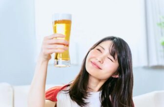 Woman drinking low calories non alcoholic beer in social setting