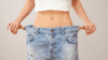 Woman wearing oversized pants after weight loss and wondering why cant I lose weight and how to achieve lasting results