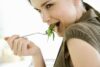 woman eating chicken breast low in calories healthy protein meal
